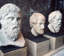 Busts of ancient Greek philosophers Plato, Aristotle, and Socrates.
