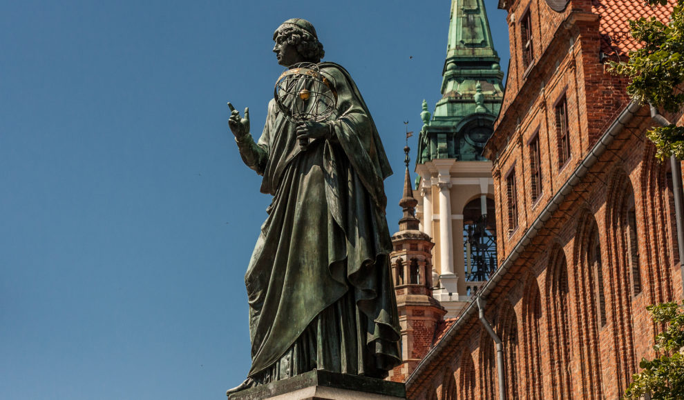 The Nicolaus Copernicus Monument in the astronomer's home town of Toruń, Poland. Copernicus, famous for developing a heliocentric model of the universe, was a devout Catholic.