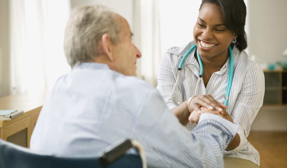 Nurse and elderly man spending time together